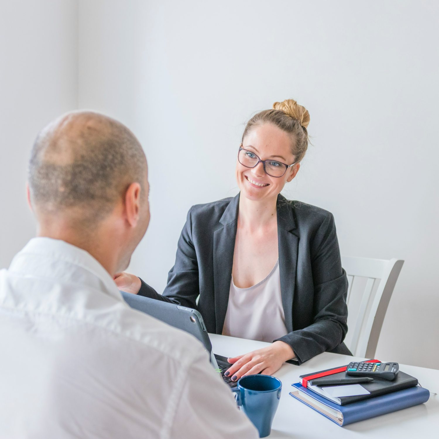 happy-businesswoman-looking-her-partner-office