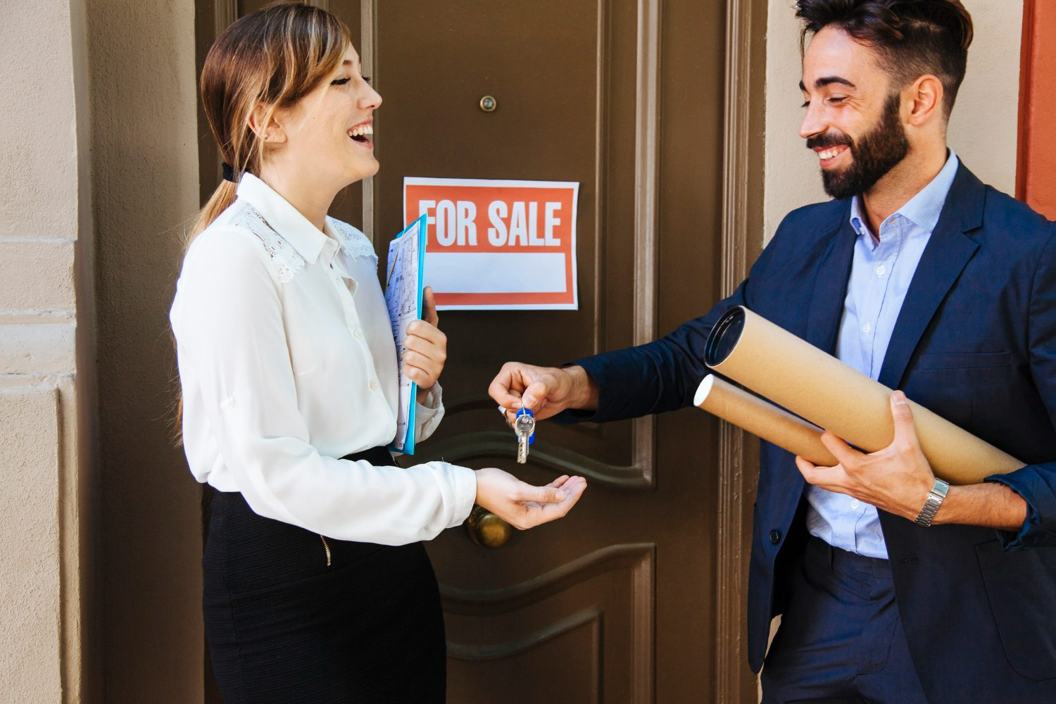 real-estate-agent-giving-key-woman