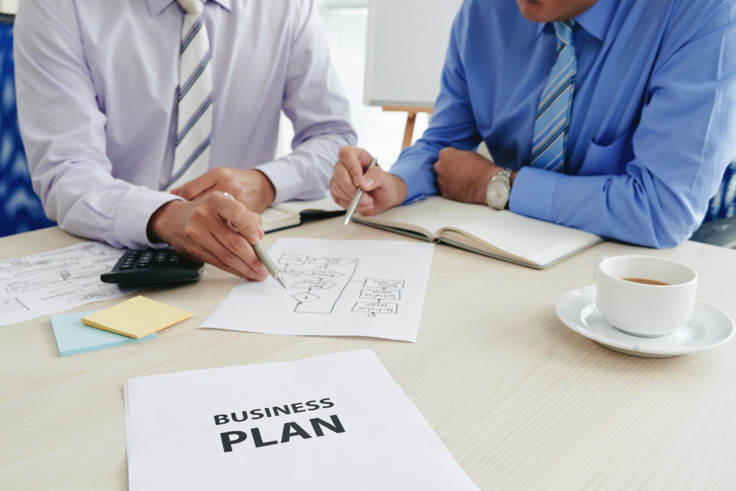 two-cropped-startuppers-developing-business-plan